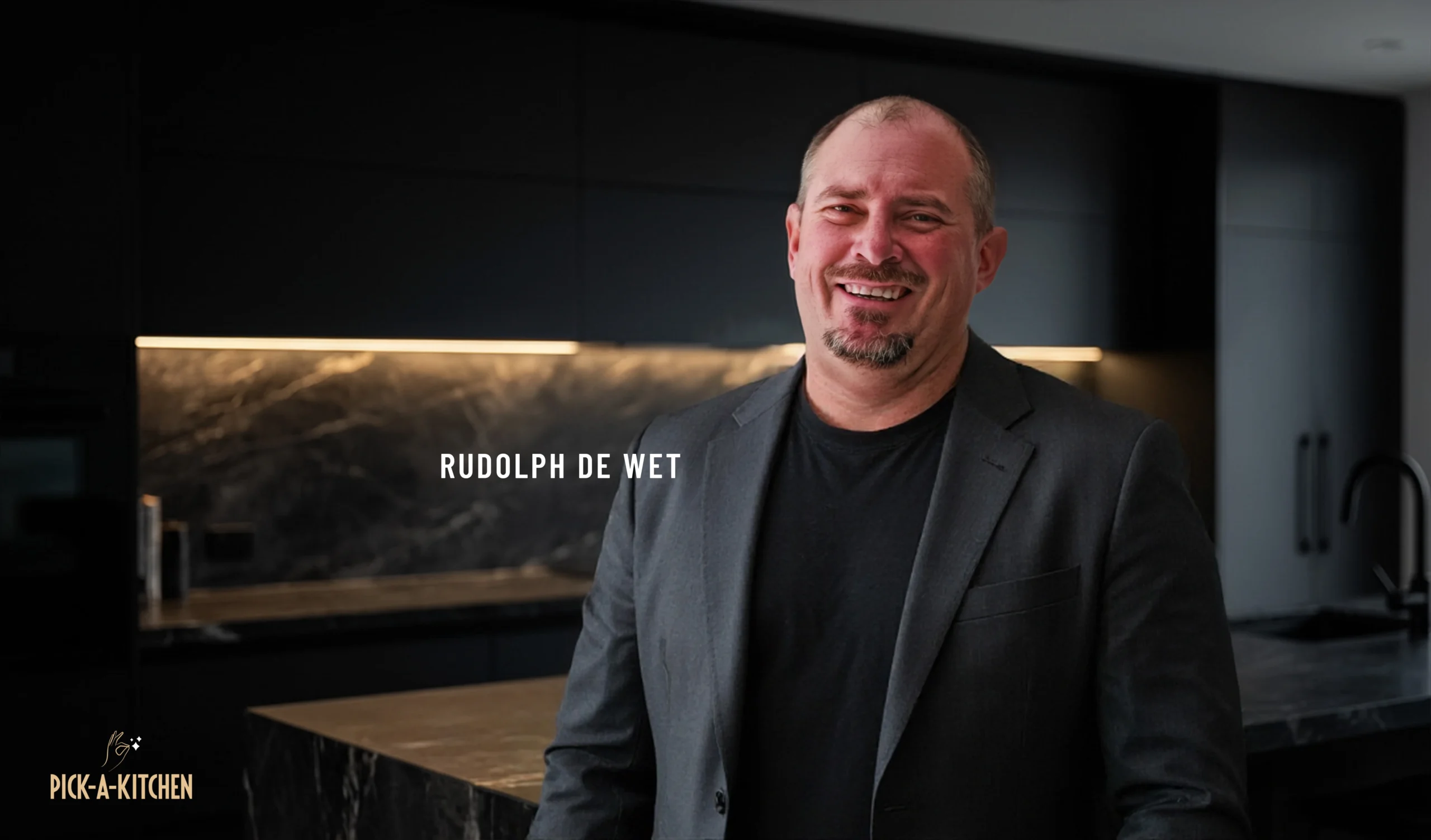 Rudolph de Wet in a modern dark themed kitchen from Pick a kitchen